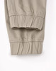 A pair of unisex cotton stretch drill cuffed work pants in khaki, featuring elastic cuffs and a simple design.