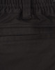 A close-up of black cotton stretch drill work shorts, featuring an elastic waistband and pockets.