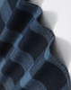 A close-up of a navy blue and black plaid flannel fabric, showcasing its soft texture and pattern.