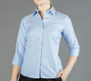 A light blue button-up shirt with a fitted design and three-quarter length sleeves. It features a collar and branding.