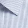 A close-up of a light blue shirt fabric featuring a subtle pattern with fine lines. It has a collar detail.