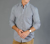Button-up shirt in a black and white gingham pattern. Features long sleeves and a standard collar. Includes a logo.