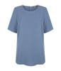 A light blue short sleeve shirt with a round neckline and a back zipper, featuring a subtle brand logo.