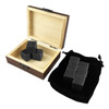 A wooden box containing grey stone whiskey ice cubes, with a black velvet pouch beside it holding additional cubes.
