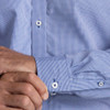 A blue and white checked button-up shirt featuring long sleeves and a classic collar, with visible buttons.