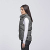 A grey puffa vest with a high collar and side pockets, displayed on a model from the side.