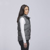 A grey puffa vest features a zip front and side pockets, worn over a long-sleeve white top.