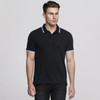 A black polo shirt with white trim and a logo, displayed on a model.