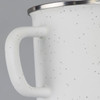 A matte enamel mug in white with black speckles and a stainless steel rim. It features a sturdy handle.