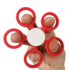 A hand holding a red fidget spinner with five circular grips, featuring a white centre.