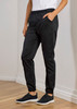 Black jogger pants with an elastic waistband and pockets, styled for women's chefwear. The model pairs them with black sneakers.