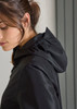 A black women's rain jacket featuring a hood, with a close-up view of the model's profile.