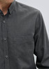 A black and grey patterned long sleeve button-up shirt with a single chest pocket and a logo.