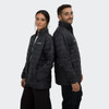 A black puffer jacket featuring a logo, worn by two people standing back to back.