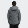 A women's puffer jacket in grey with a hood, featuring a chevron quilted design and a logo on the back.