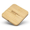 A bamboo wireless fast charging hub with a square design and a port on the side. It features a subtle logo on top.