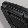 A medium-sized wheeled suitcase with a textured black surface and a green trim, featuring a sturdy handle.