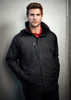 A man wearing a black unisex jacket with red accents and a zippered pocket, featuring a logo.