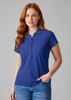 A blue polo shirt for women, featuring a standard collar and button placket, showcased on a model.