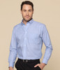 A blue button-up shirt with a collar and a chest pocket, featuring a model wearing it against a neutral background.