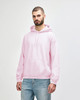 A man wearing a pink Gildan Heavy Blend adult hooded sweatshirt with a front pocket and hood.
