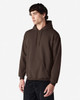 A brown hooded sweatshirt with a kangaroo pocket and a logo. The model is standing against a plain white background.