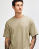A heavyweight cotton unisex t-shirt in khaki, featuring short sleeves and a relaxed fit. It has a logo.