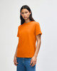 An orange heavyweight cotton unisex T-shirt on a model, paired with light blue jeans.