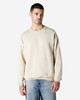 A beige Gildan Heavy Blend adult crewneck sweatshirt displayed on a model, featuring a relaxed fit and long sleeves.