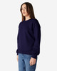 A navy Gildan Heavy Blend adult crewneck sweatshirt displayed on a model wearing blue jeans.
