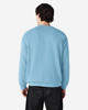 A light blue crewneck sweatshirt, featuring a plain back and long sleeves, worn by a person facing away.