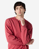 A crewneck sweatshirt in a rich red colour, featuring long sleeves and a relaxed fit. It has a logo on it.