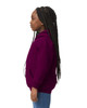 A youth hooded sweatshirt in deep purple with a front pocket and a hood, displayed on a girl with long braided hair.