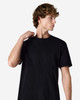 A black unisex short sleeve T-shirt worn by a model, showcasing a simple, classic design.