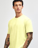 A model wearing a bright yellow unisex short sleeve t-shirt with a simple design and no visible logos.