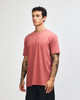 A unisex short sleeve T-shirt in a muted terracotta colour, featuring a minimalist design and a logo.