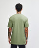 A green unisex CVC short sleeve T-shirt viewed from the back, featuring a plain design and a logo.