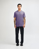 A unisex short sleeve T-shirt in purple, paired with black cargo pants. It features a logo on the shirt.