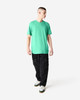 A unisex short sleeve t-shirt in vibrant green, paired with black cargo pants and styled on a male model.