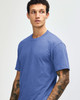 A unisex short sleeve t-shirt in a blue hue, featuring a casual fit and a logo on the chest.