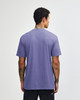 A unisex short sleeve T-shirt in purple, shown from the back, featuring a label on the neckline.