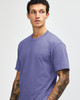 A unisex short sleeve T-shirt in a purple shade, featuring a subtle logo on the front.