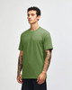 A green unisex CVC short sleeve T-shirt displayed on a model, featuring a simple design and a logo.