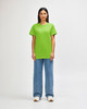 A green Gildan Heavy Cotton adult T-shirt is displayed on a model, paired with light blue jeans.