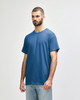 A blue Gildan Heavy Cotton adult t-shirt displayed on a model, featuring a simple design and a logo.