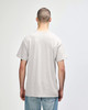 A grey Gildan Heavy Cotton adult t-shirt viewed from the back, featuring a simple design and short sleeves.
