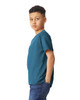 A youth t-shirt in teal, featuring short sleeves and a relaxed fit, displayed on a young model.