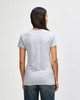 A women's grey Gildan Heavy Cotton T-shirt displayed from the back, featuring a simple design and short sleeves.