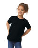 A toddler wearing a black Gildan Heavy Cotton T-shirt, featuring a logo, with curly hair and a playful expression.
