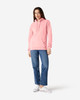A pink Gildan Softstyle adult hooded sweatshirt worn by a model with blue jeans and white shoes, featuring a logo.
